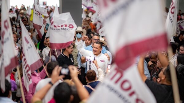Retrato profesional de Carlos Torres Piña frente a un mapa de la entidad, con íconos de encuestas y recorridos municipales