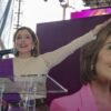 Brissa Arroyo segundo informe: diputada hablando frente a multitud en Morelia, Michoacán, con bandera de Michoacán y logo